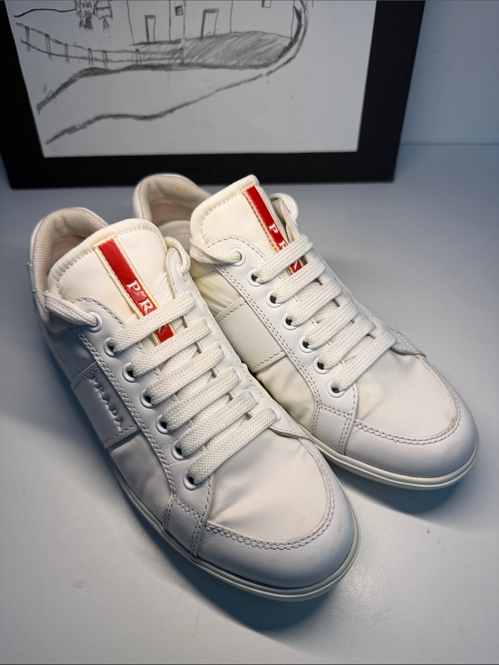 Prada women’s nylon and leather comfort, sneakers, in white. US size 7.
